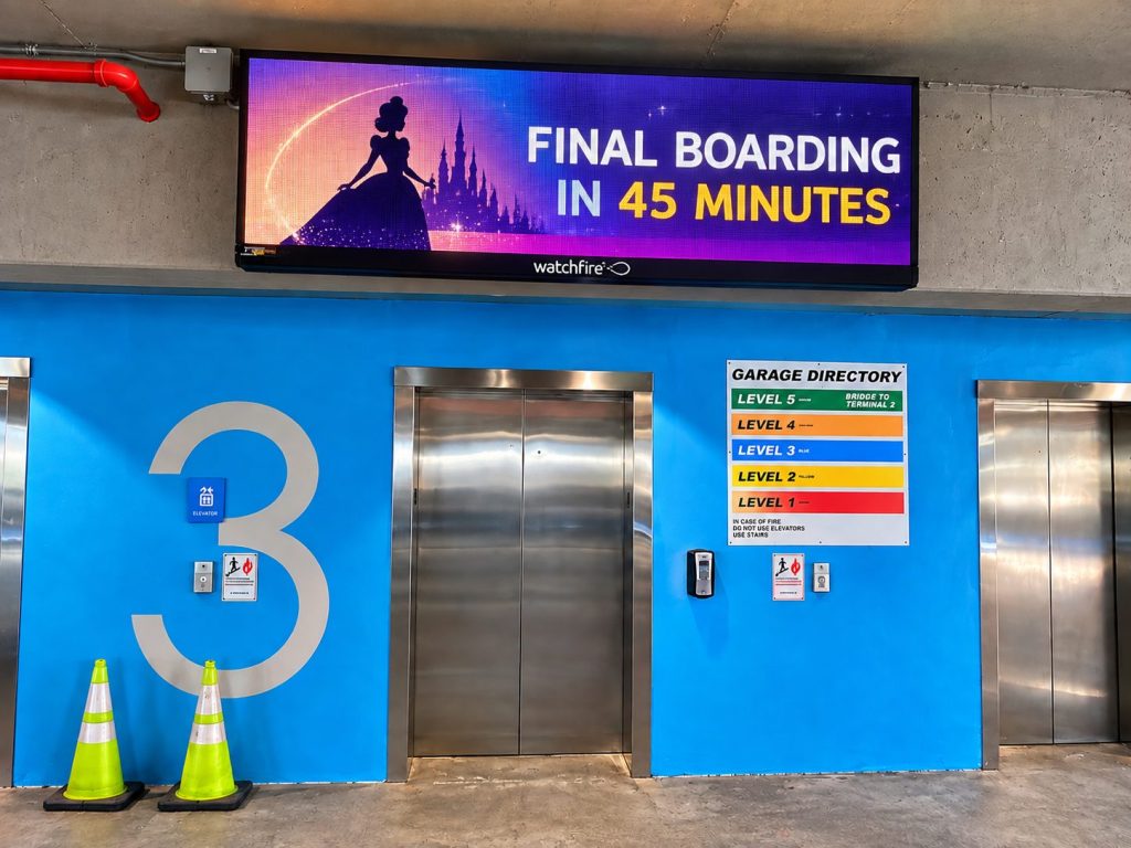 Electronic message center above a blue garage elevator lobby