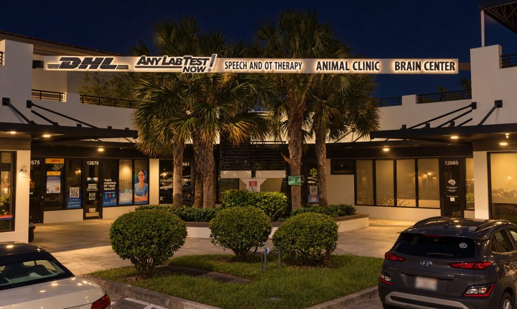Shopping plaza storefronts at night with illuminated channel letter signs