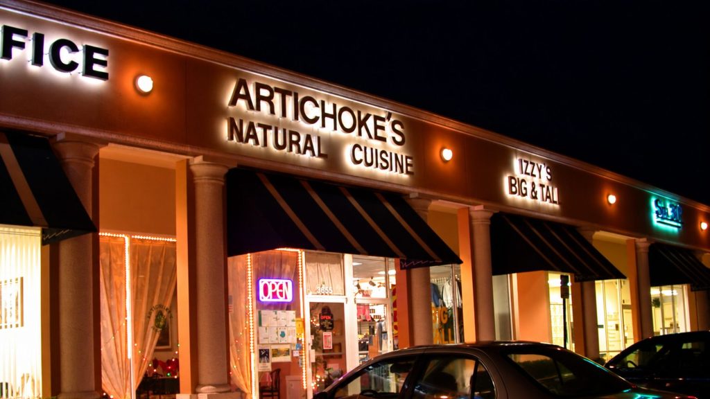 Artichoke's Natural Cuisine storefront at night