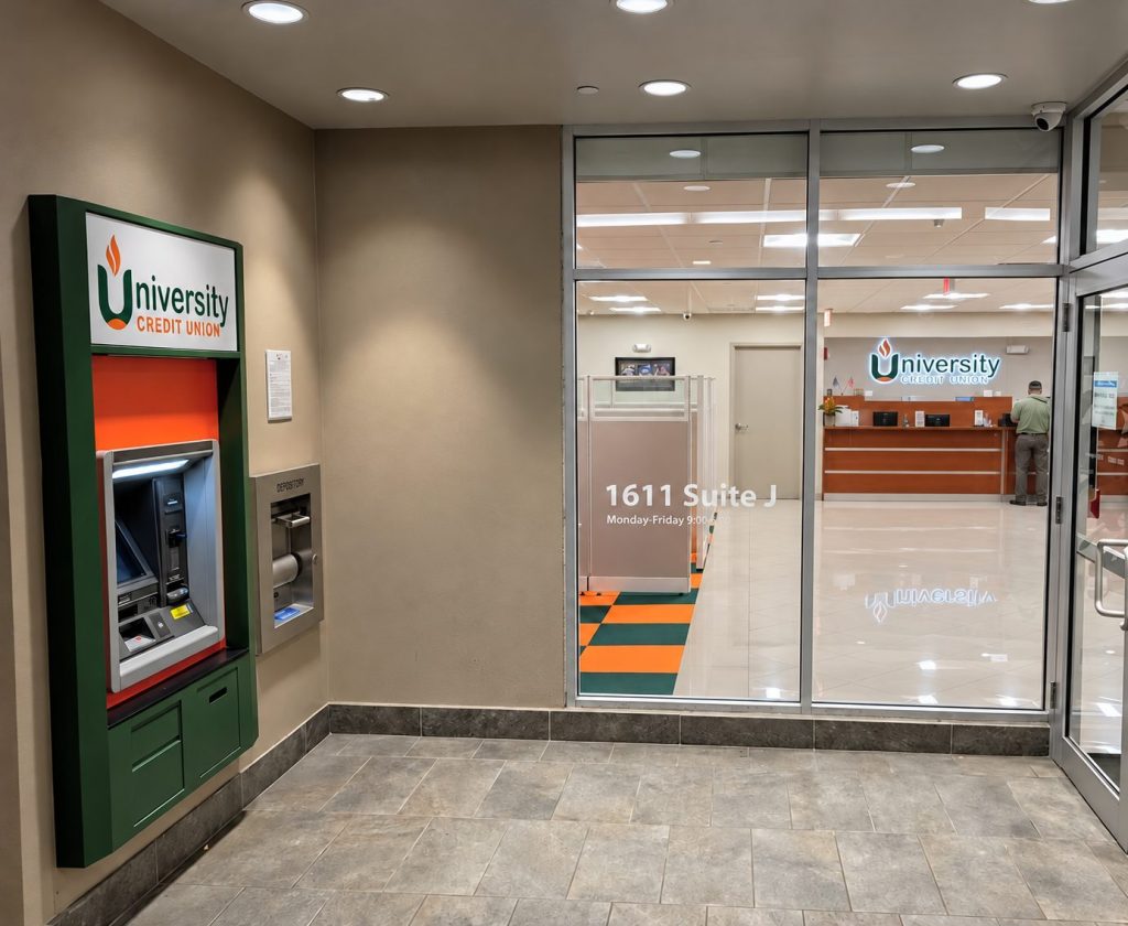 Illuminated credit union sign beside an ATM in the lobby