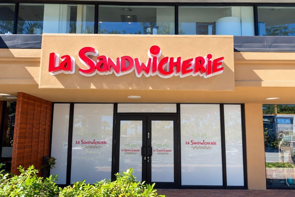 La Sandwicherie storefront with red channel letters in daylight