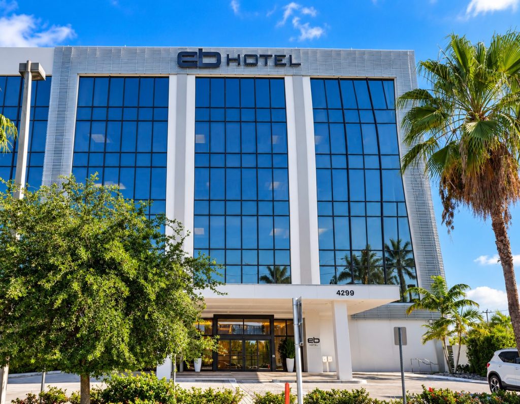 EB Hotel facade under a blue sky