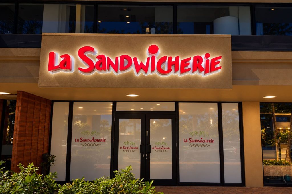 La Sandwicherie front and back lit sign at night
